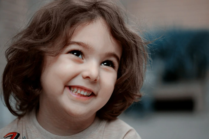 a little girl with a smile on her face